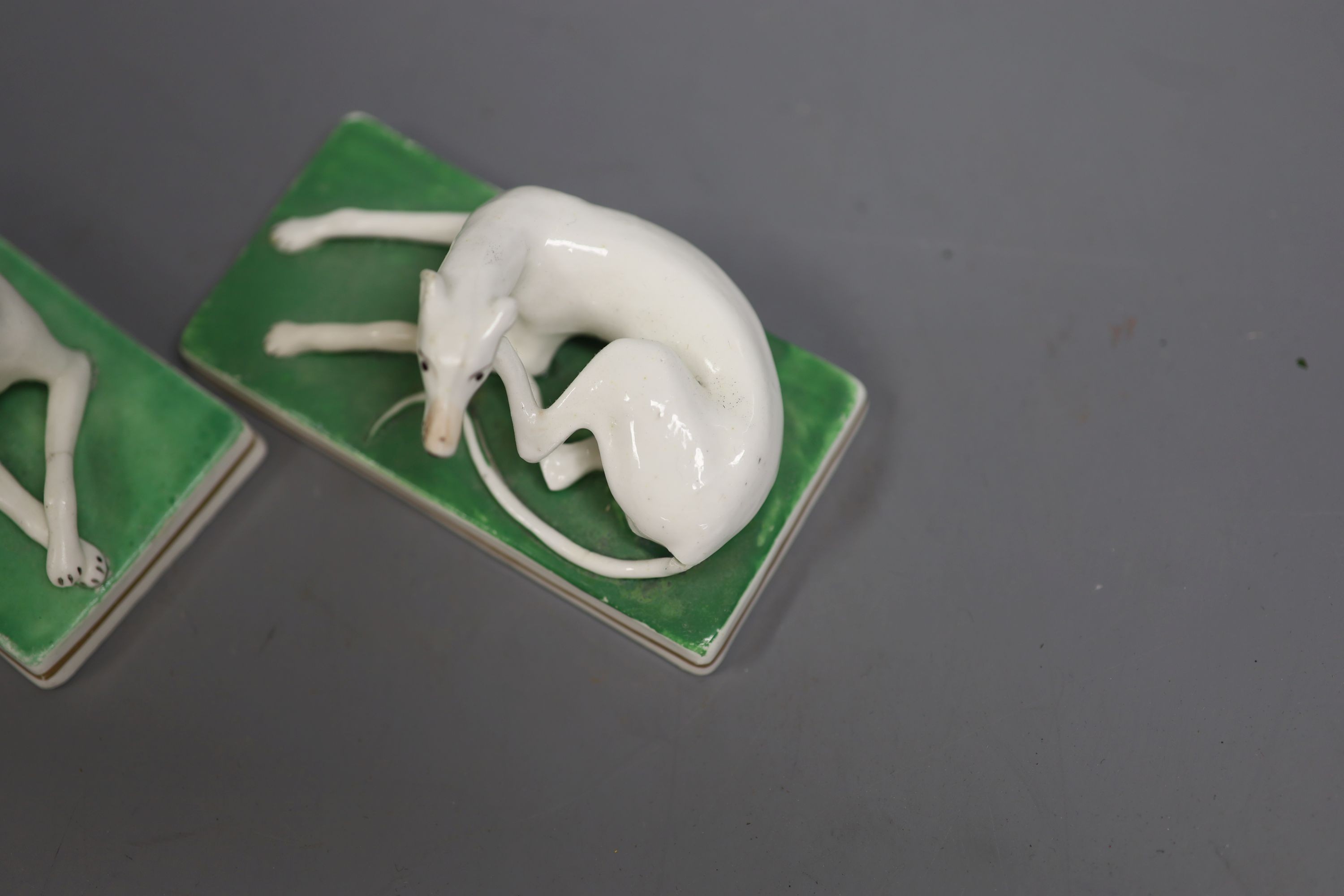 A pair of Staffordshire models of greyhounds, c.1830-50, each on rectangular bases, 10.2cm long